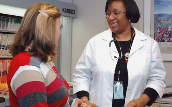 Doctor wearing a headset consulting with medical staff near equipment